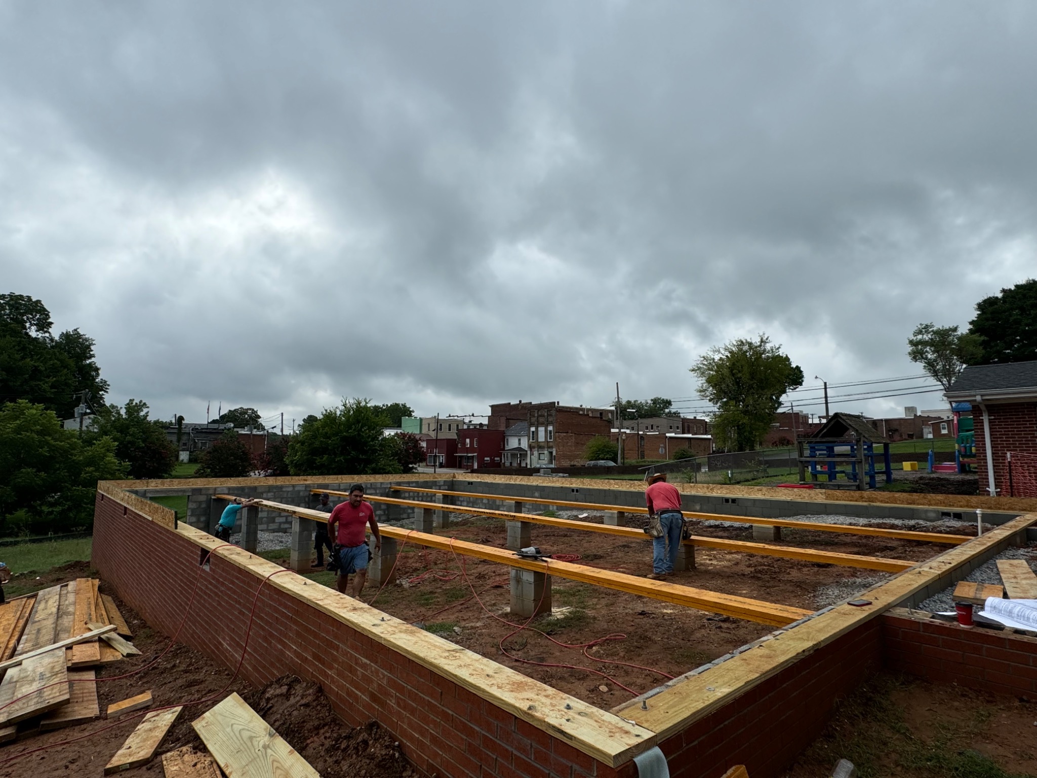 Structural beams being installed over the foundation