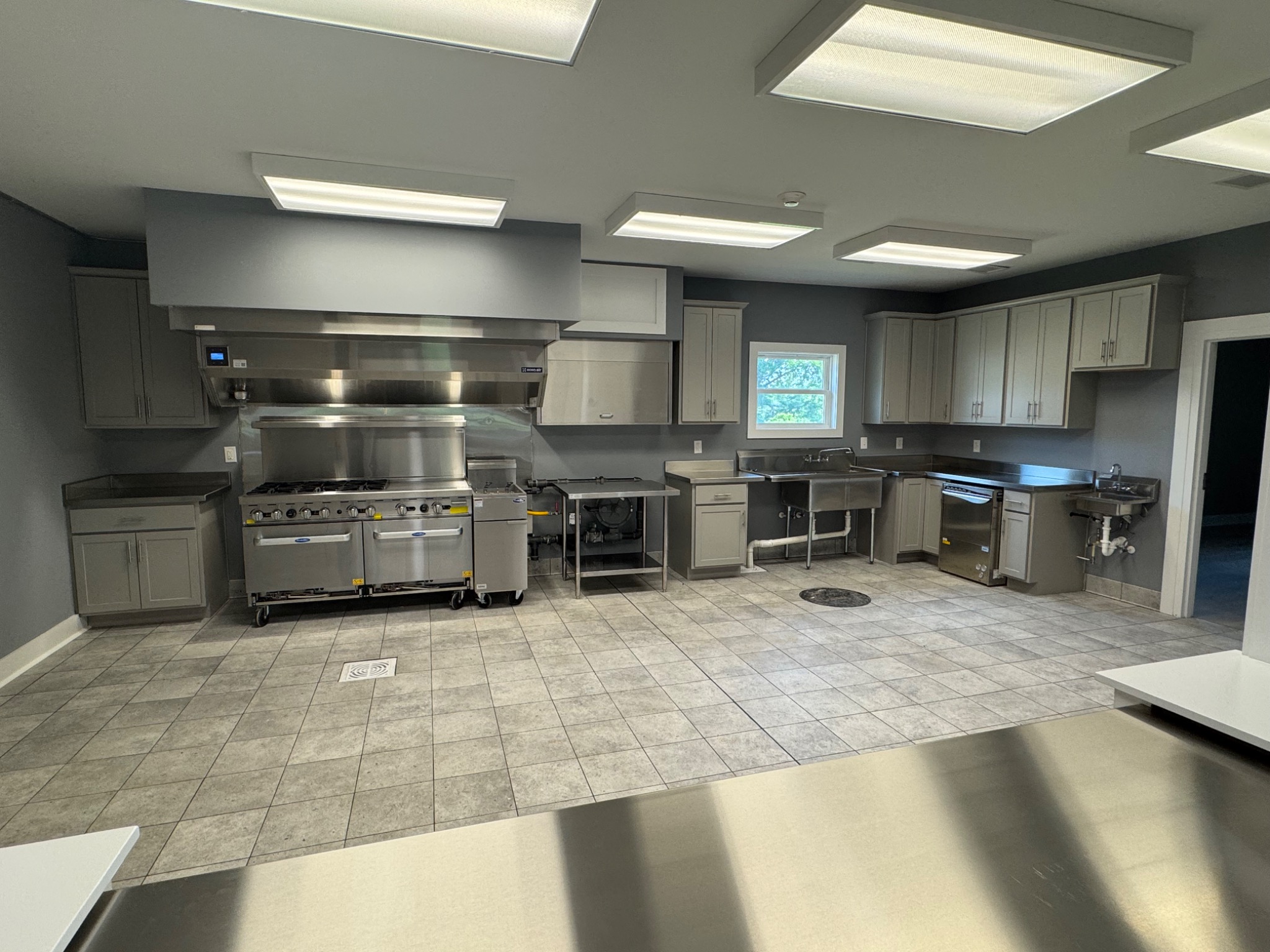 Completed commercial kitchen with stainless steel equipment