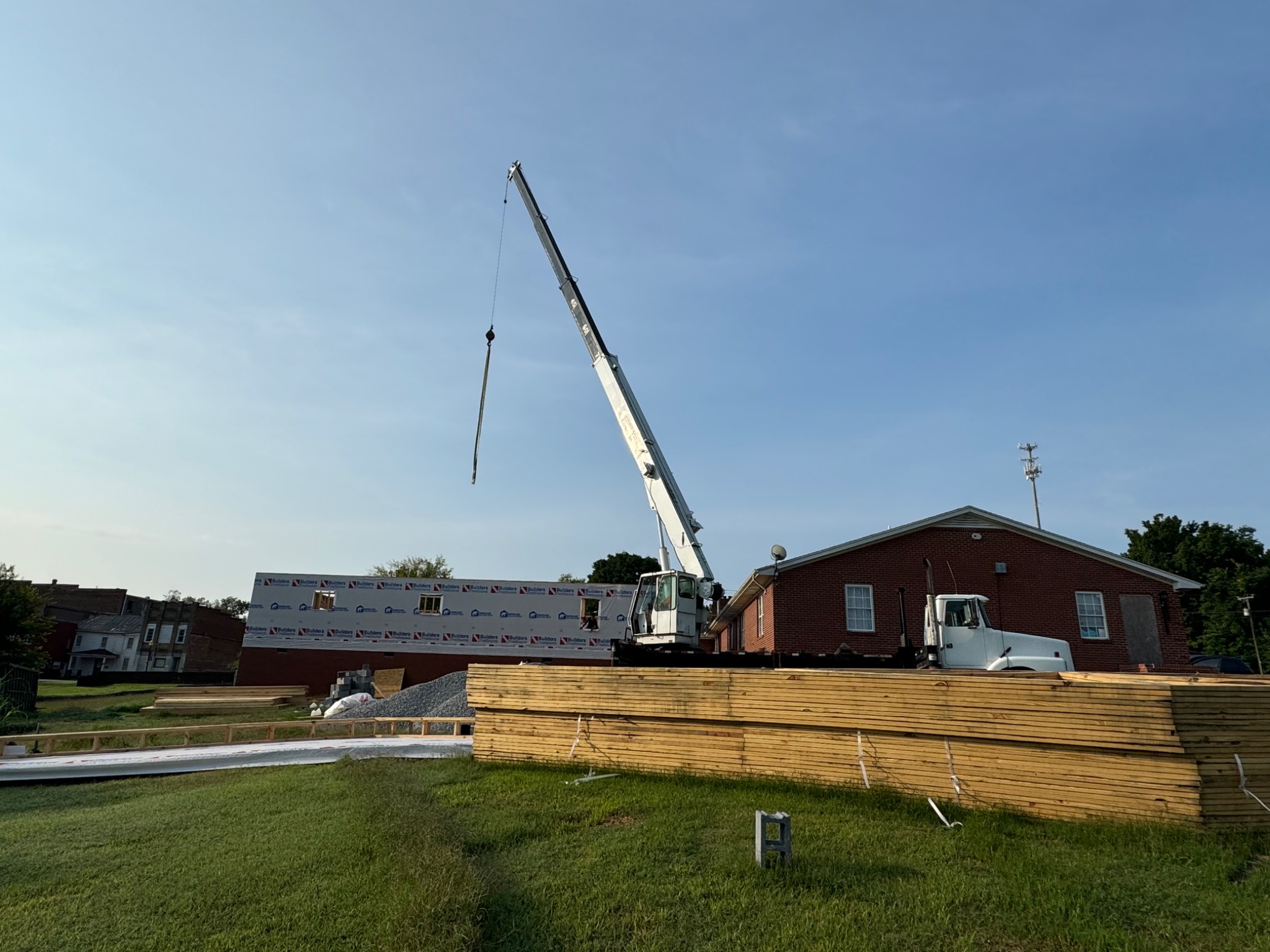 Crane assisting with framing and roof construction