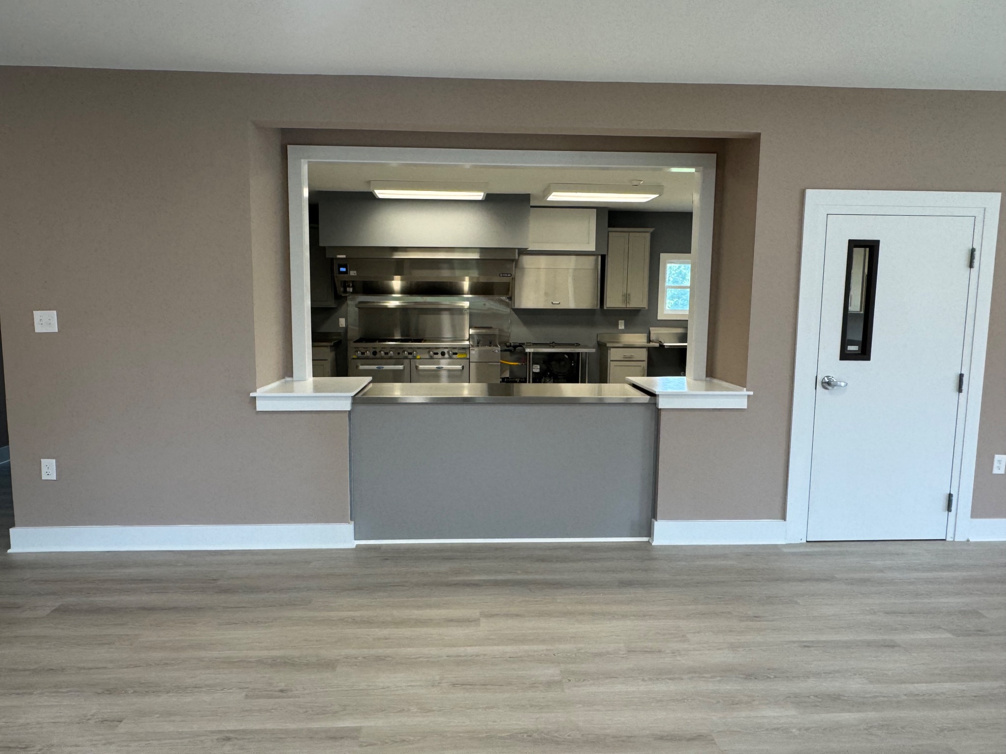 Serving opening into completed commercial kitchen