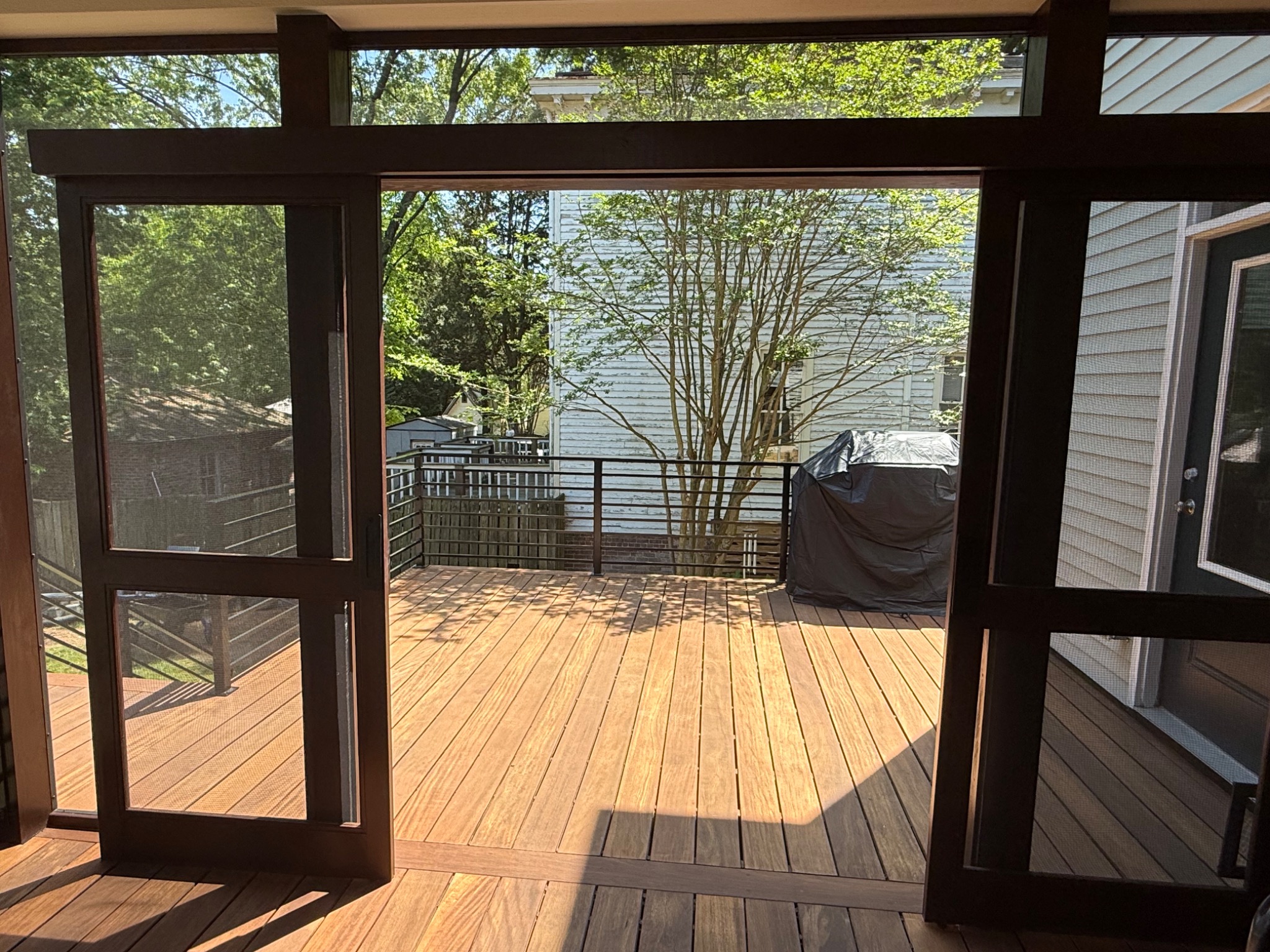 View from screened porch toward open hardwood deck