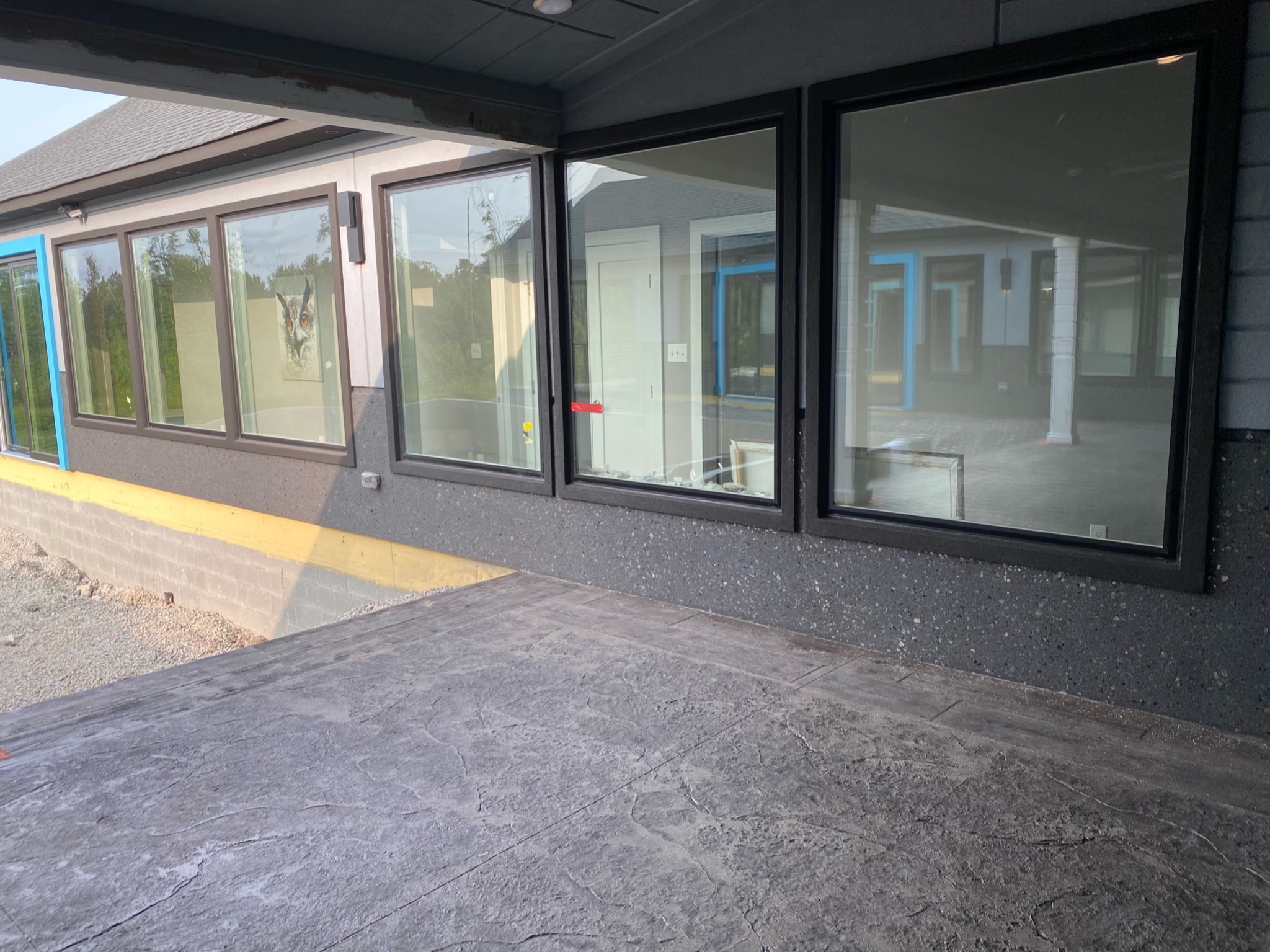Courtyard-side windows and stamped concrete patio at the custom ranch home
