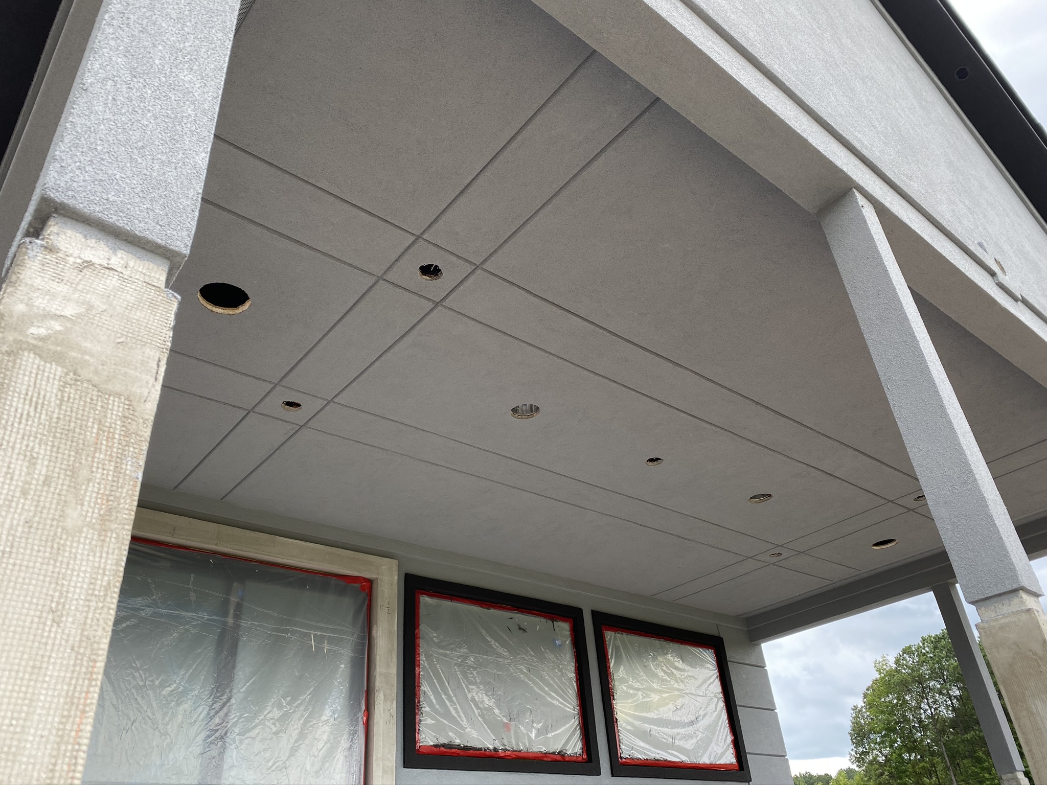 Finished covered porch ceiling with EIFS columns and recessed lighting