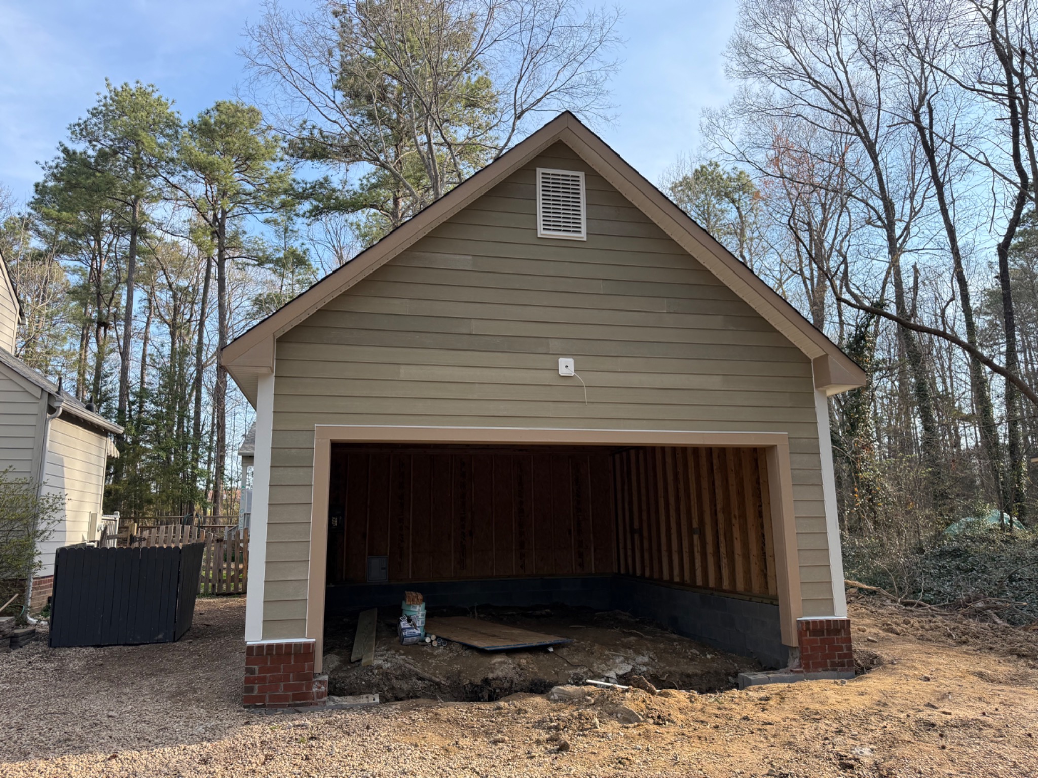 Front of detached garage with siding and trim installed