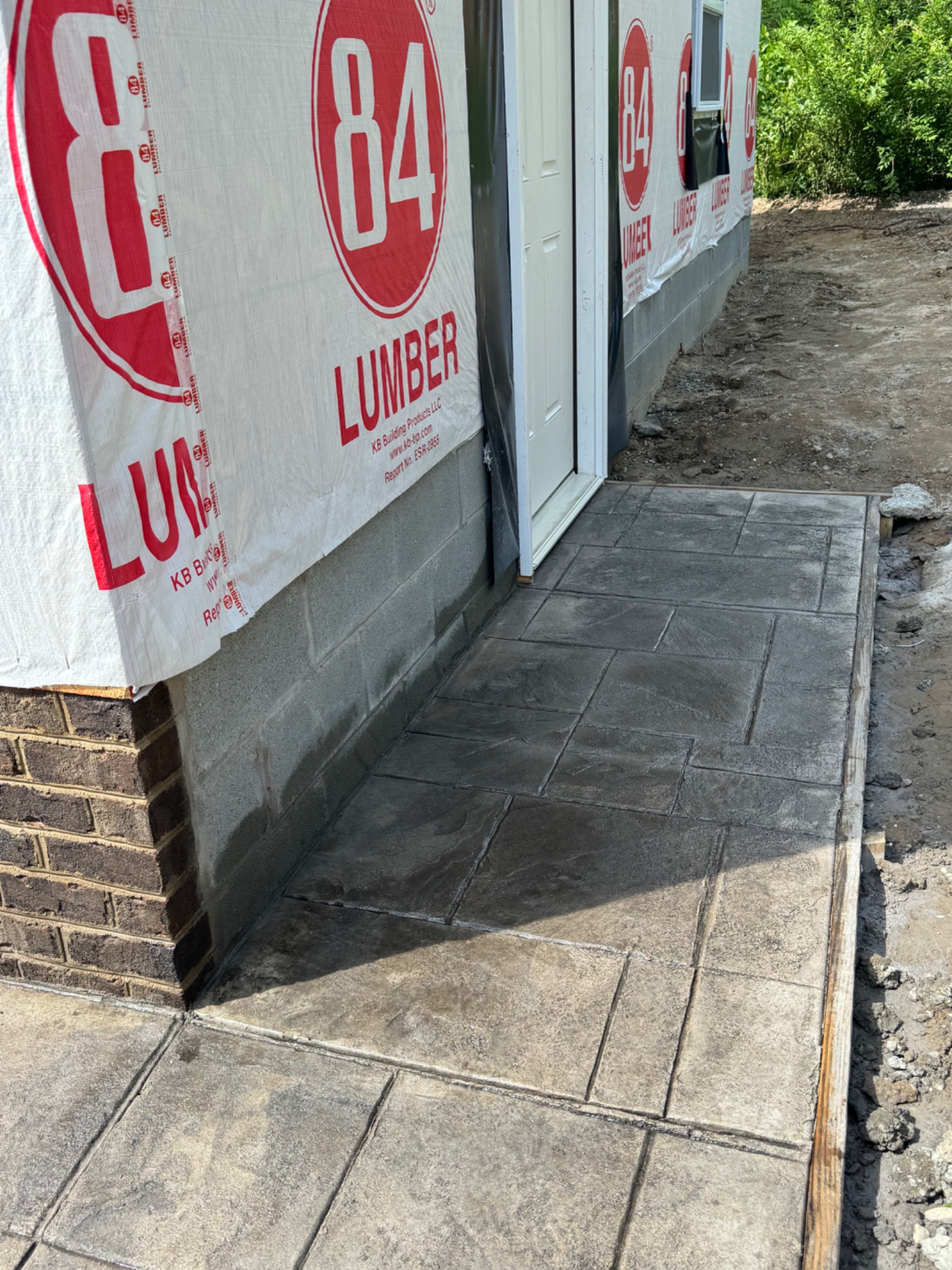 Stamped concrete walkway detail beside garage entry