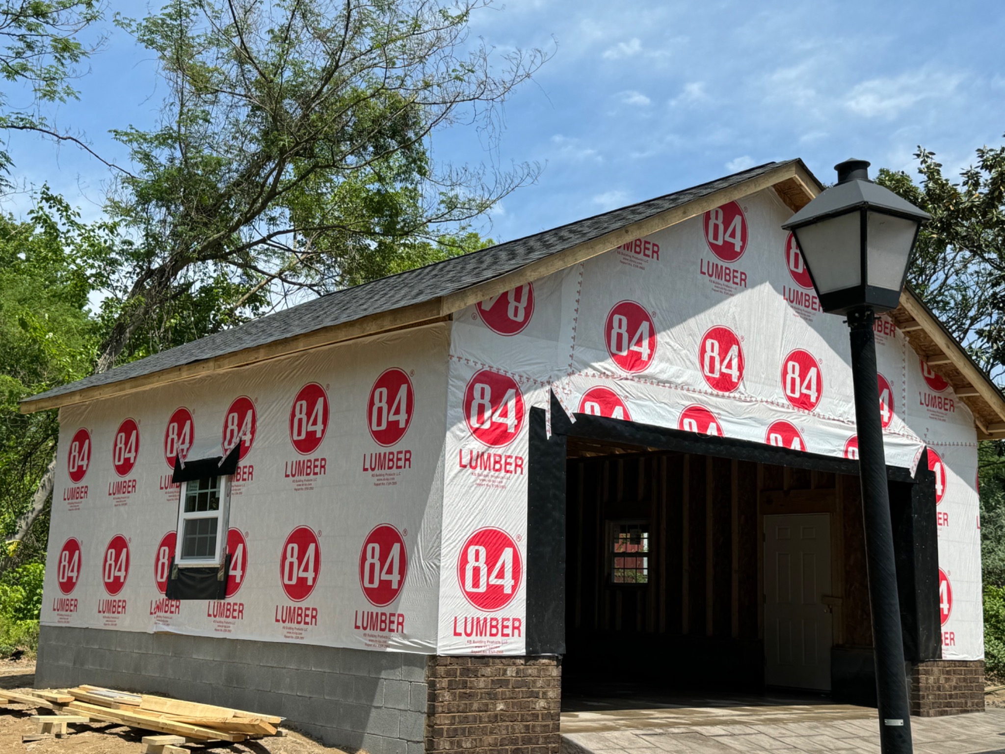 Detached garage wrapped with windows and entry door installed
