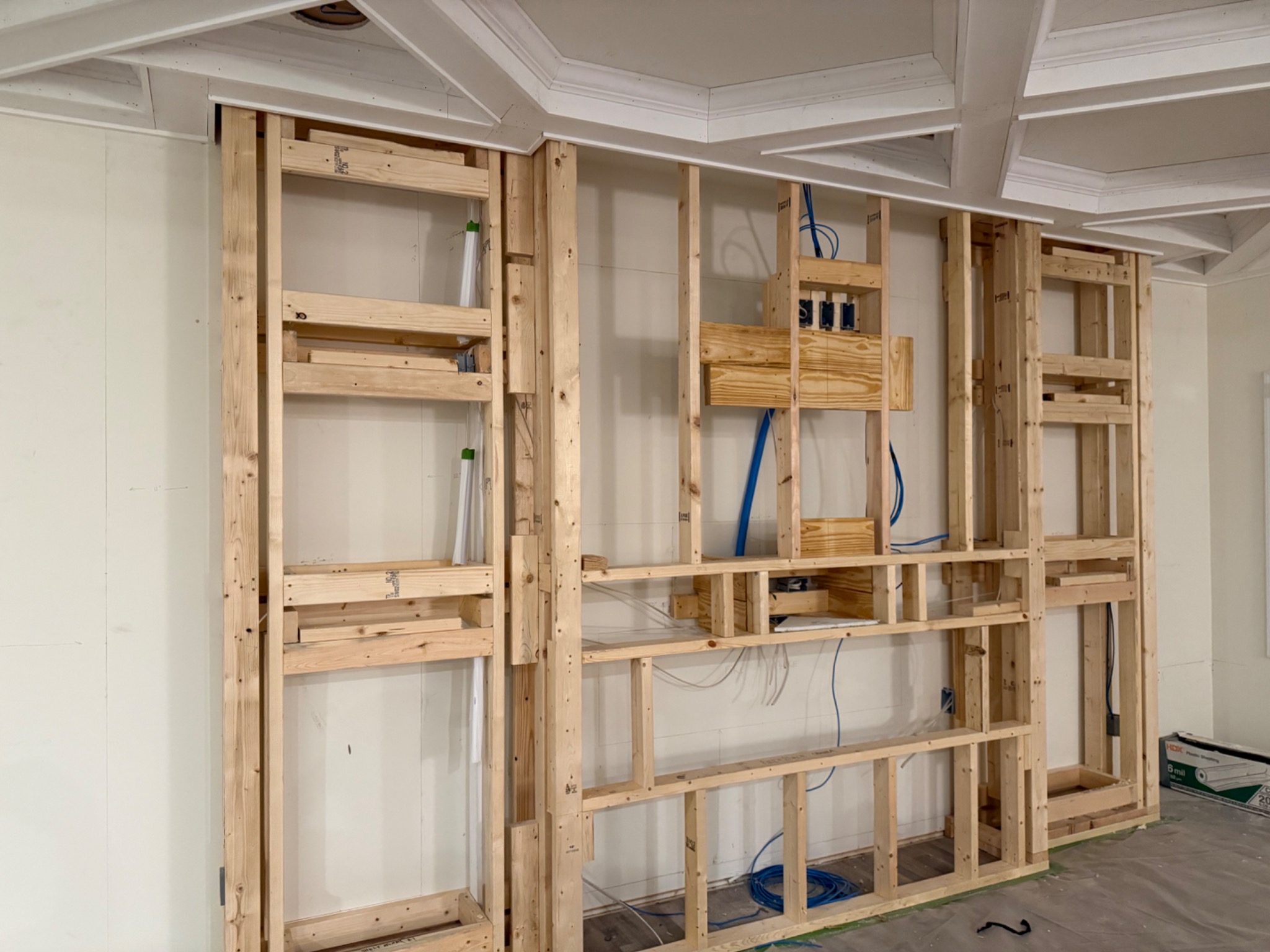 Framed entertainment wall with display niches and electrical wiring rough-in