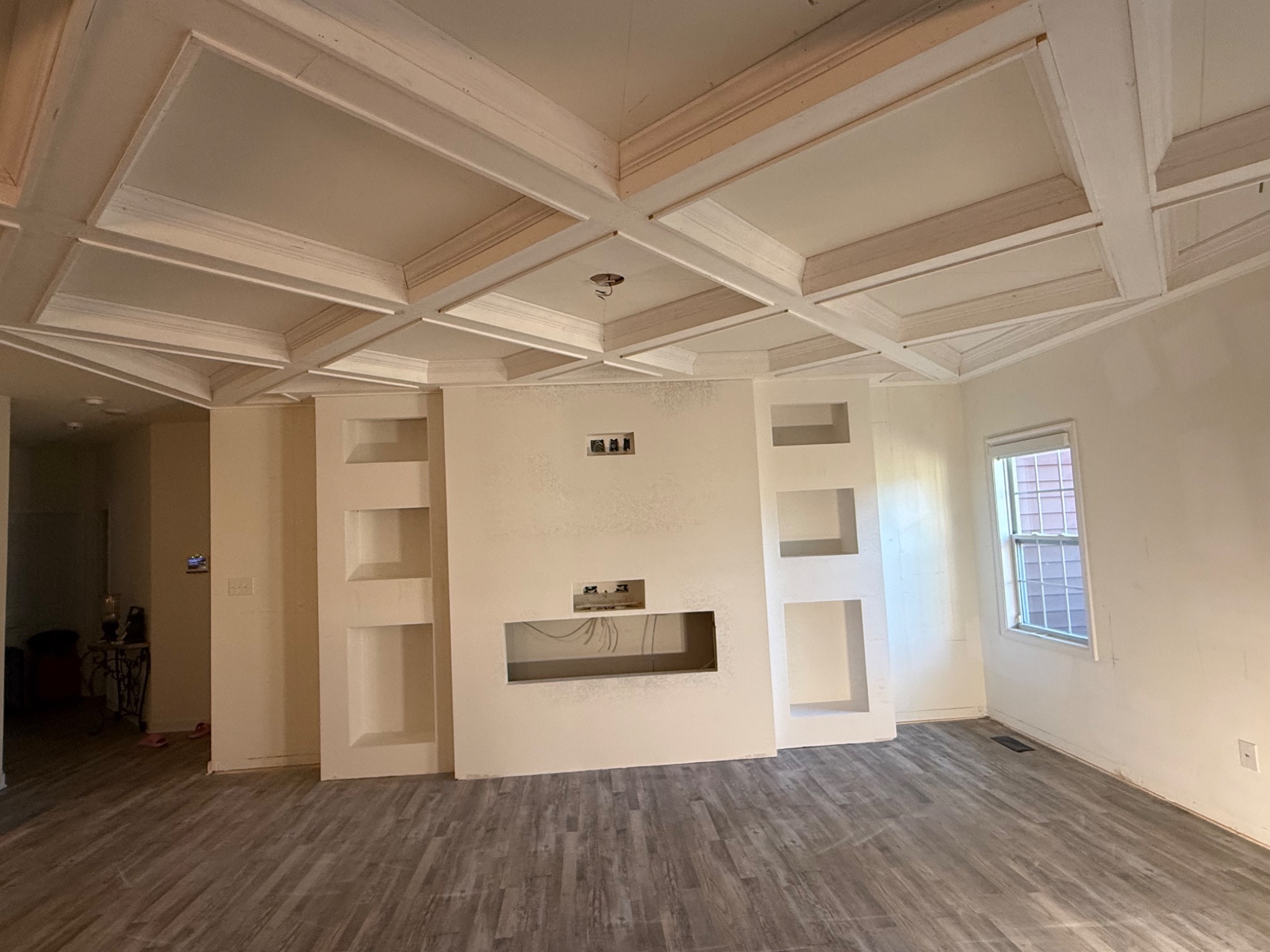 Entertainment wall and coffered ceiling primed before final paint