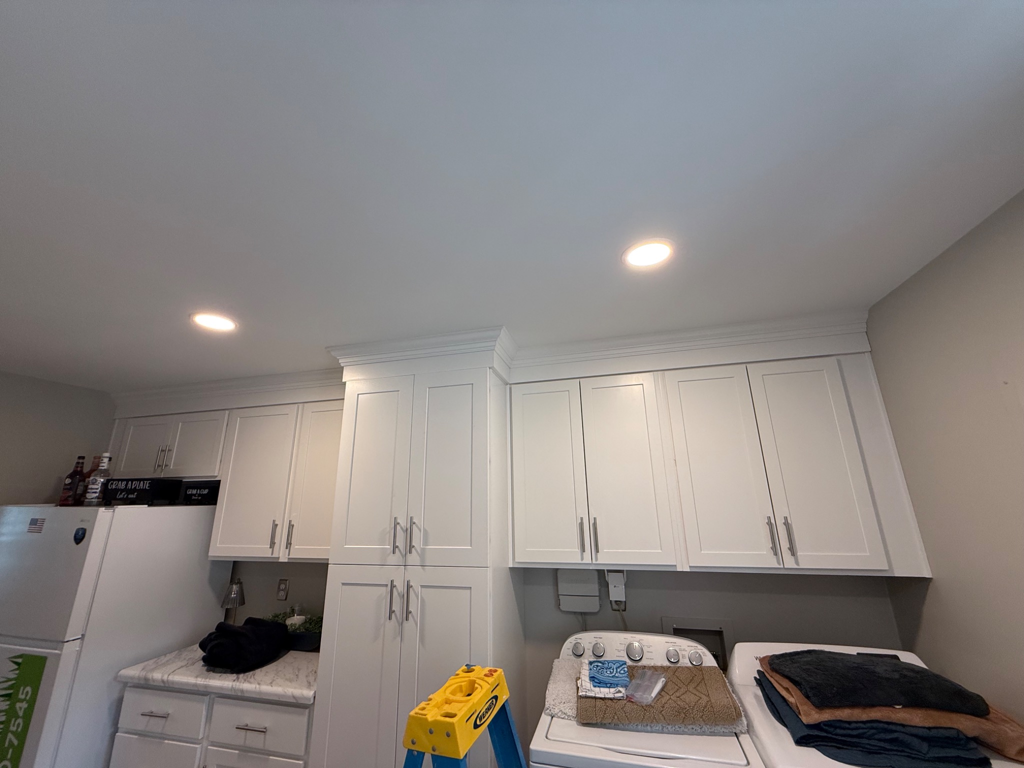 Upper cabinets, crown molding, and recessed lighting in finished office conversion