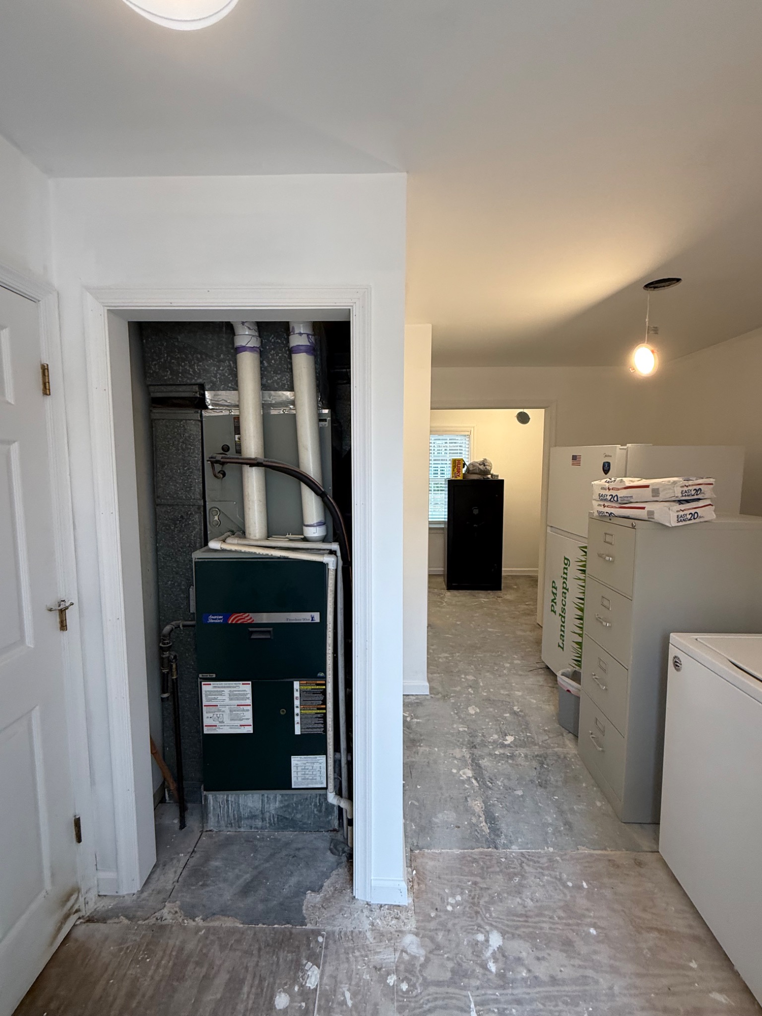 Finished trimmed HVAC access enclosure within renovated utility space