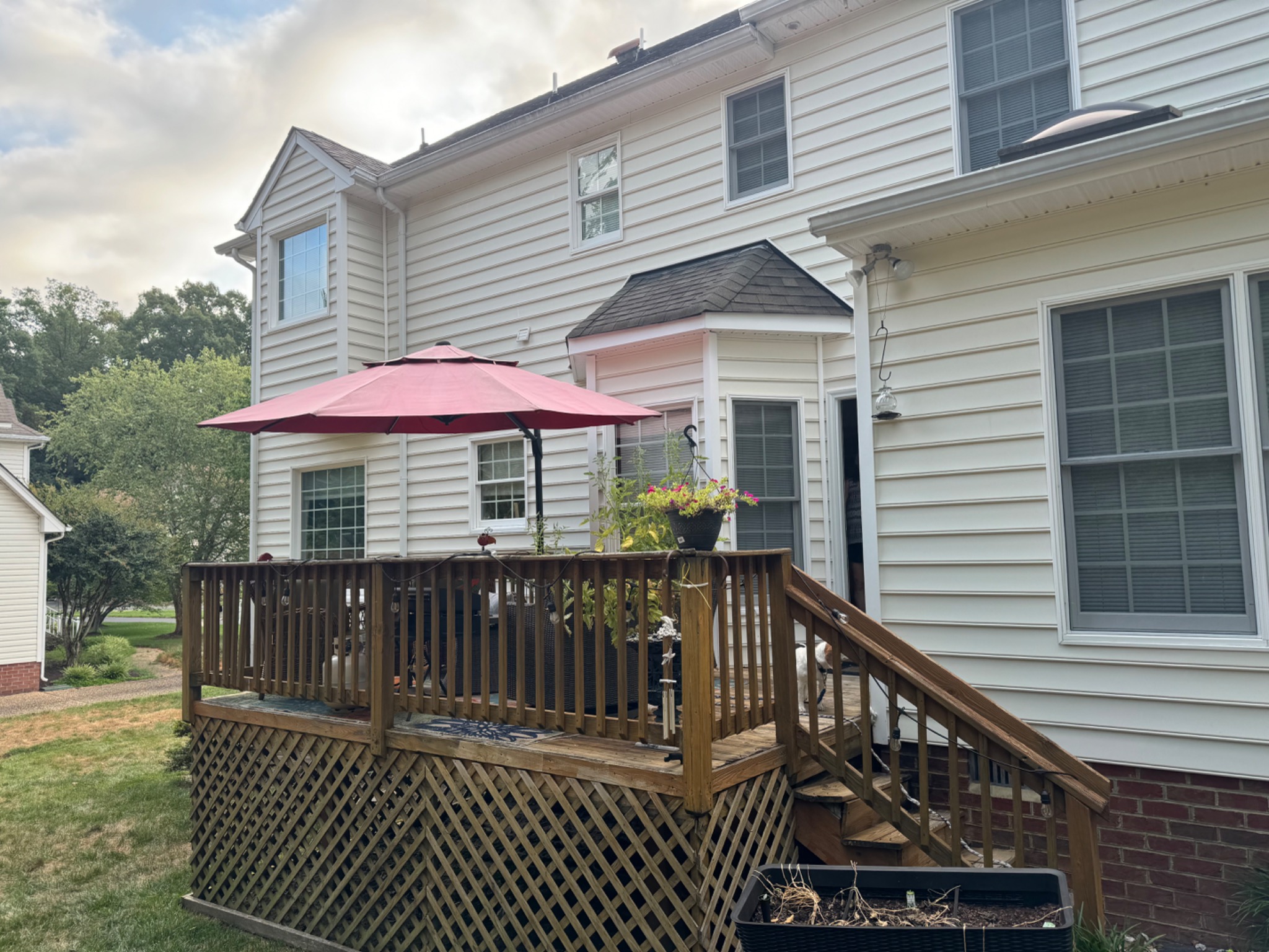 Existing wood deck and rear elevation before screened porch renovation