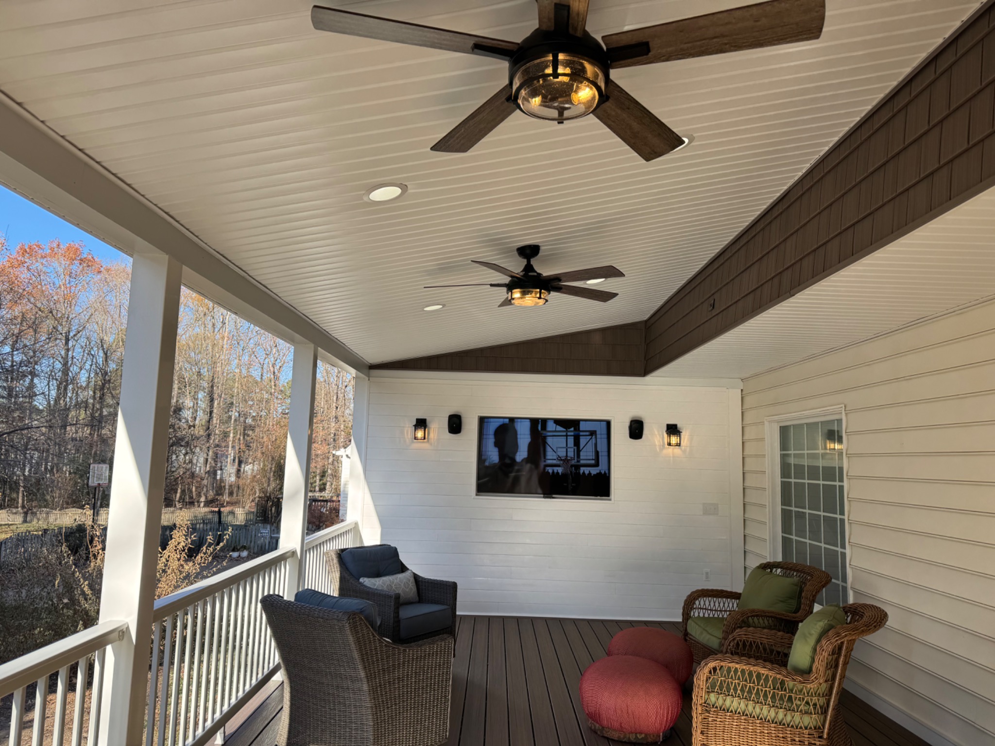Completed screened porch from side angle with white columns and railings