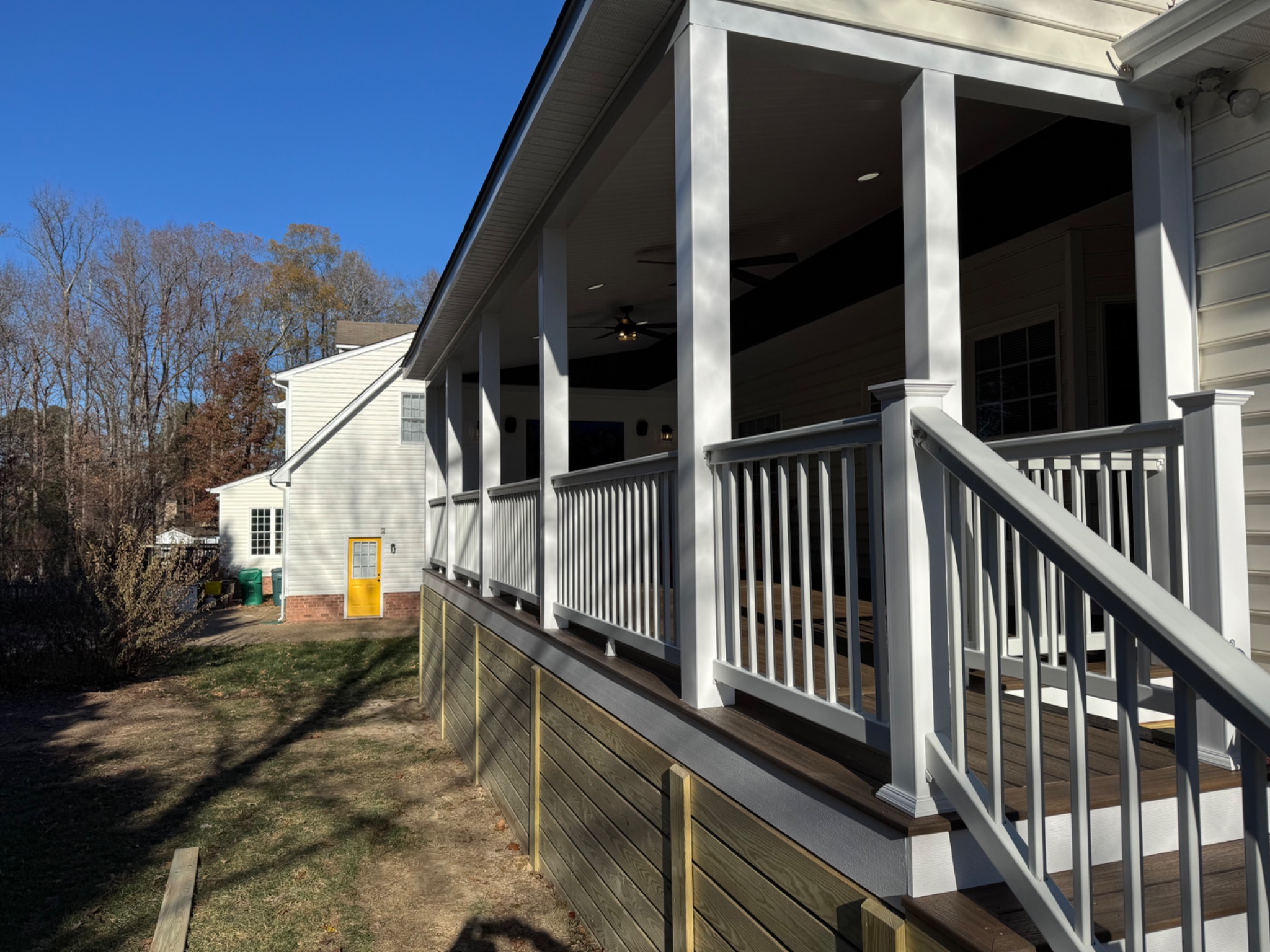 Completed 520 square foot screened porch with full-width covered roof and railings