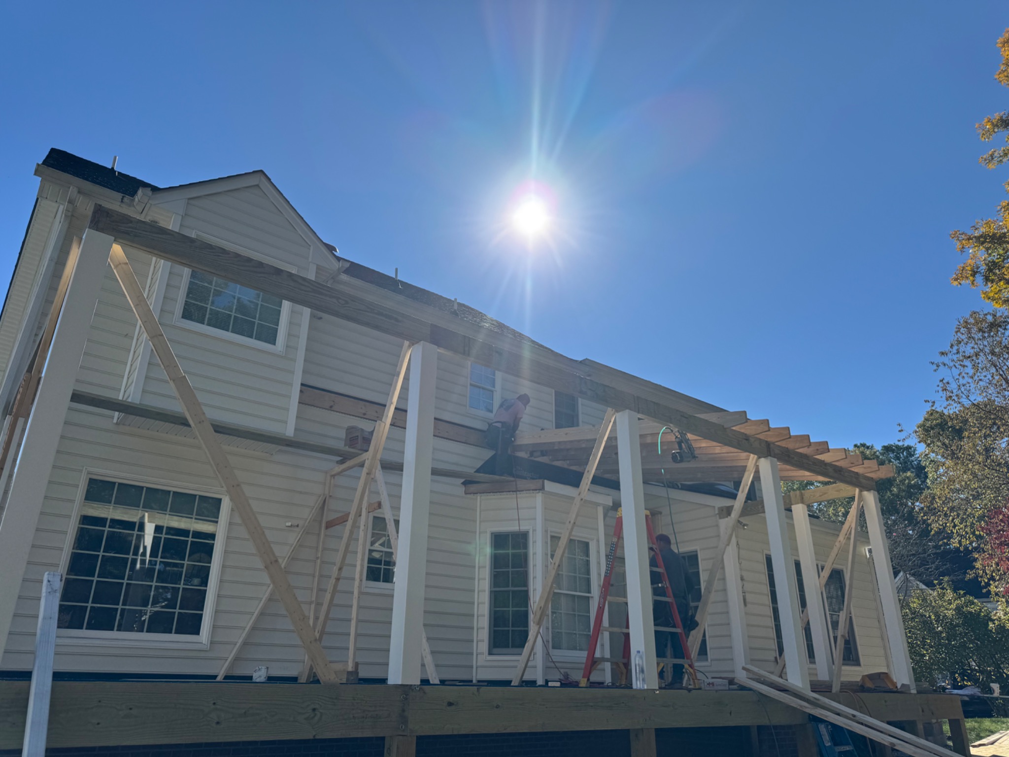 Porch roof framing and support columns during construction