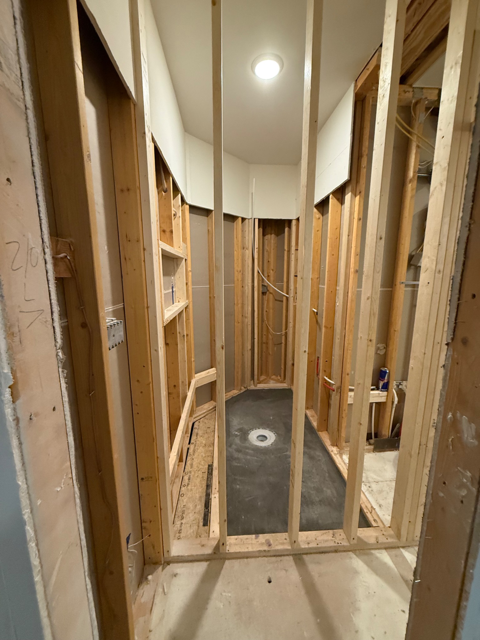 Zero-clearance shower area framed with recessed shower floor and drain