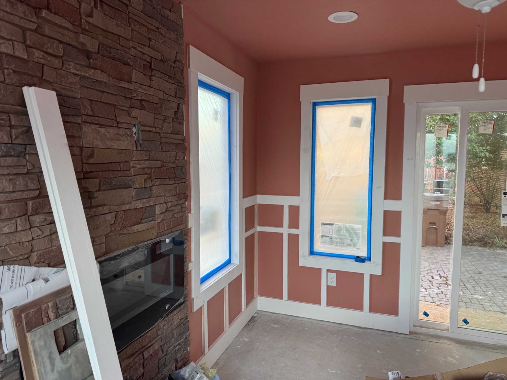 Sunroom interior finish work with stone fireplace and custom trim