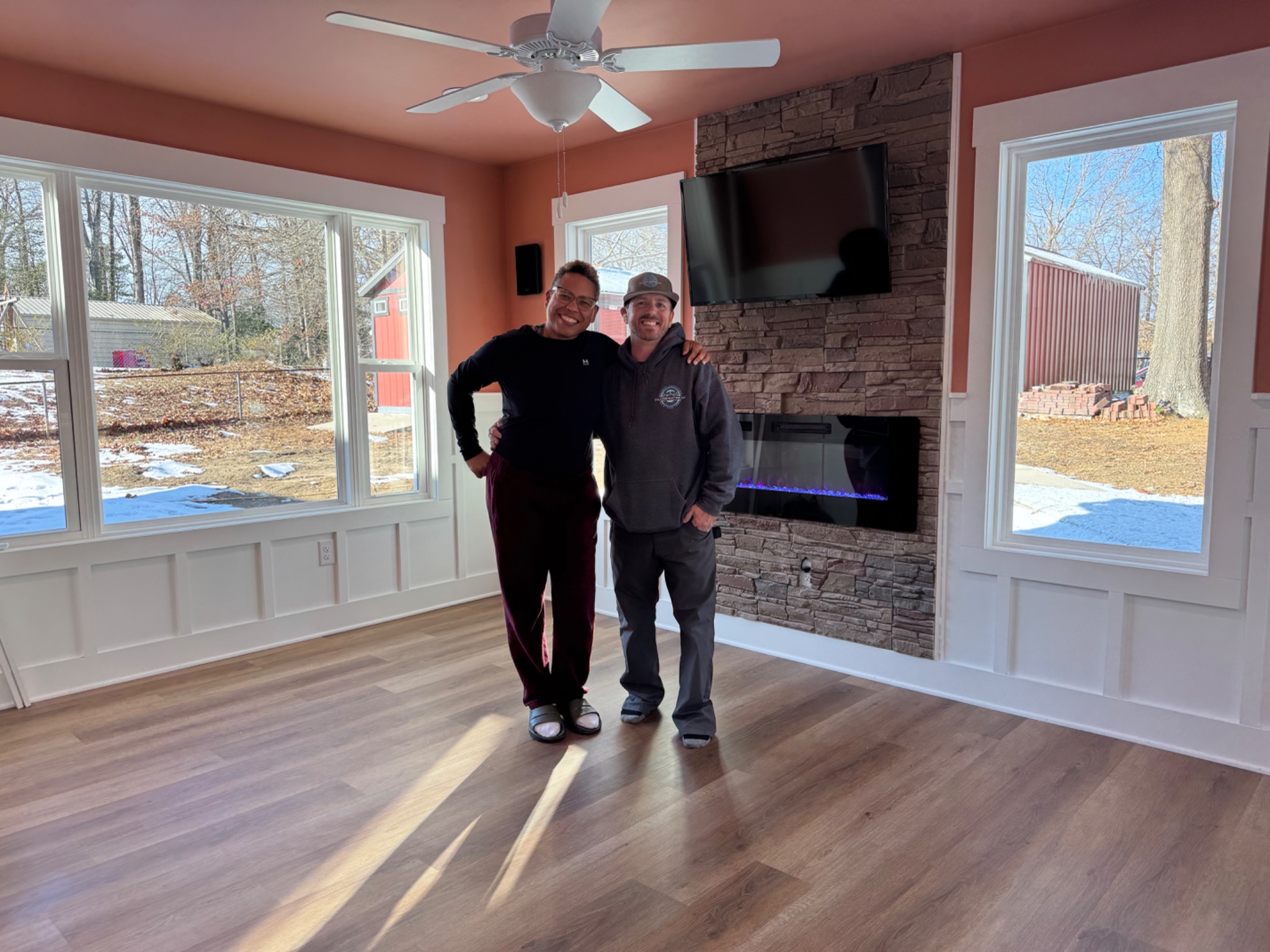 Completed sunroom project with homeowner and contractor